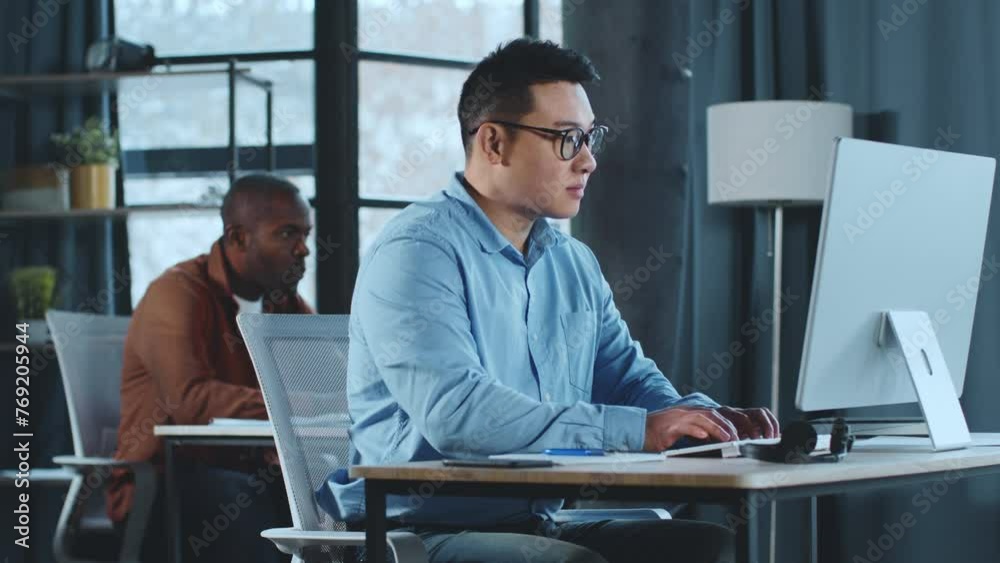 Poster Man Using Computer at Desk