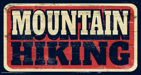 Aged and worn mountain hiking sign on wood