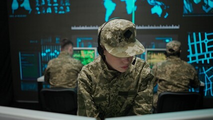 Group of security squad in control center. Military headquarters surveillance officers cyber police working in office, female technician giving instructions.