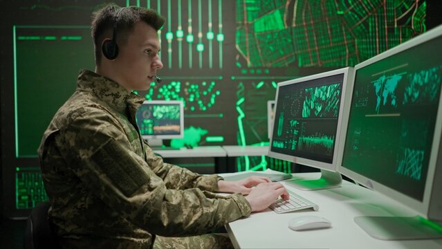 Person security squad in control center. Military headquarters surveillance officer cyber police working in office, tracking and managing security, back shot.