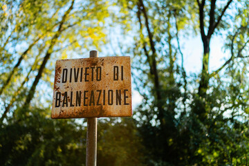 Swimming prohibition sign, located close to the lake, Italy
