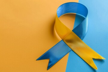 A ribbon with blue and yellow stripes is on a yellow and orange background