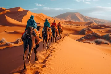  A group of travelers is journeying through the desert landscape on camels, with the vast sky above and rugged mountains in the distance © RichWolf