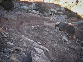 Close up shot of switchback in mountain bike trail in desert landscape in Moab Utah