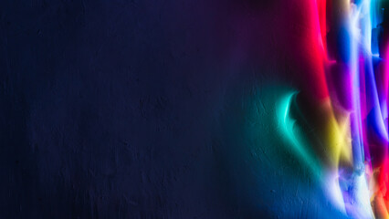 Abstract colorful irregular lines on black background and wall texture. Long exposure. Light...