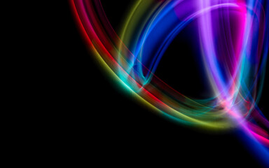 Abstract colorful irregular lines on black background and wall texture. Long exposure. Light painting photography.
