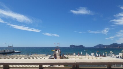 Private beach umbrellas and sea view at La Croisette, Cannes, French Riviera, summer vacation