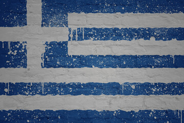 colorful painted big national flag of greece on a massive brick wall
