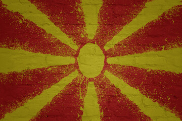 colorful painted big national flag of macedonia on a massive brick wall
