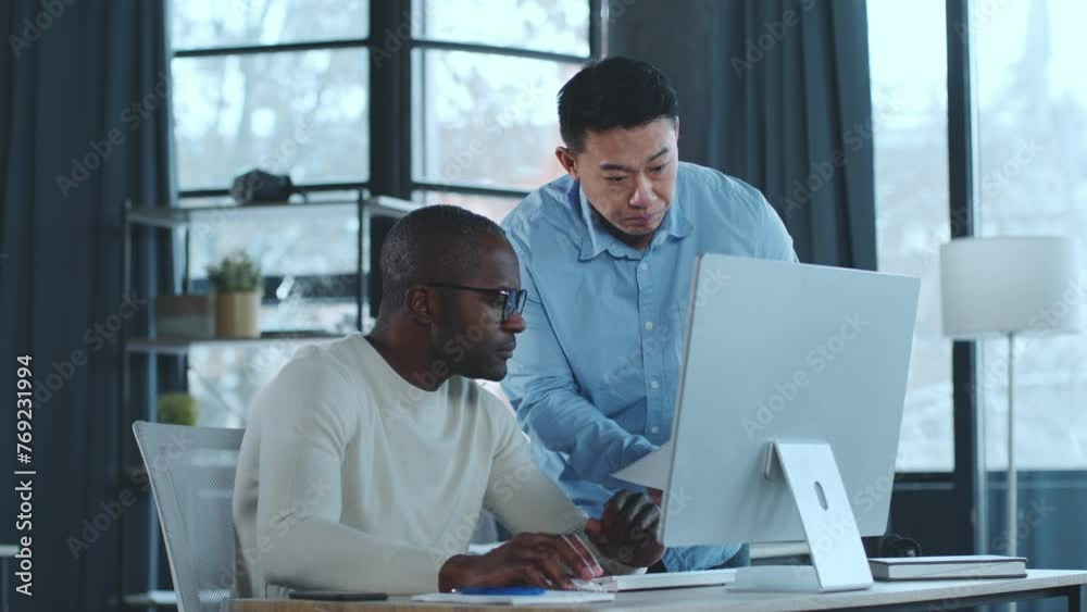 Poster two men looking at computer screen