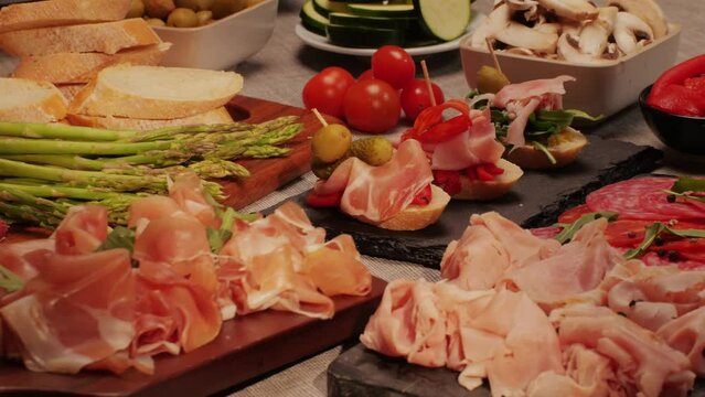 Italian or Spanish restaurant with traditional tapas food, Spanish cuisine, delicious tapas and cheese plate, bruschetta with cheese, olives dry tomatoes and tasty sandwich bar appetizer, buffet
