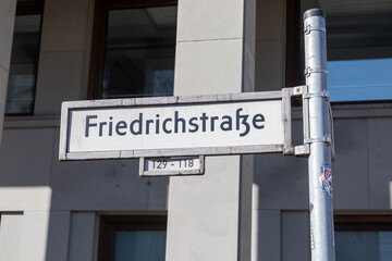 street name sign Friedrichstrasse as symbol of the former DDR part of Berlin