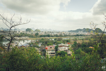 Summer landscape of Guilin town city with karst mountains in the background
