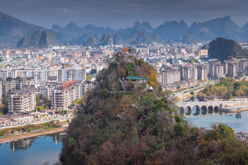 Overview of mountainous Guilin city at noon with sunset cloud