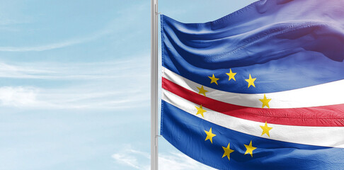 Cabo Verde national flag with mast at light blue sky. - obrazy, fototapety, plakaty