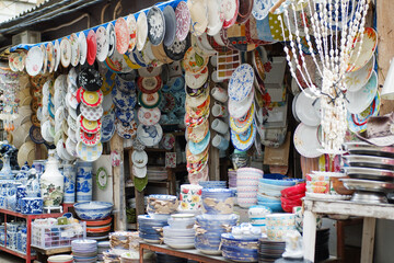 Ceramic shop with colorful ceramic oriental pottery, plates and other handicrafts at a market stall