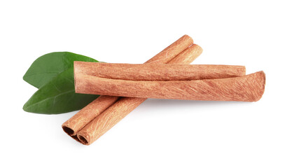 Cinnamon sticks and green leaves isolated on white
