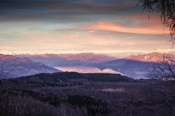 Sunset in the snowed mountain, pink lights on the lake. Swiss Alps, after snowfall, seen from Mottarone mountain (Stresa side). Piedmont - Italy.