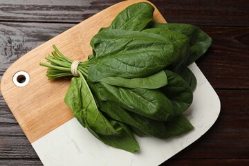 Bunch of fresh spinach leaves on wooden table, top view