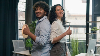 Excited multiracial colleagues business partners Arabian Indian man businessman and Hispanic woman...