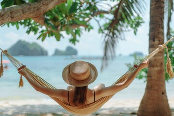 Woman relaxing on beach in hammock under palm