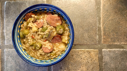 homemade Cajun sausage gumbo with rice, bell peppers, celery, okra, and onions in a spicy roux - 769248732