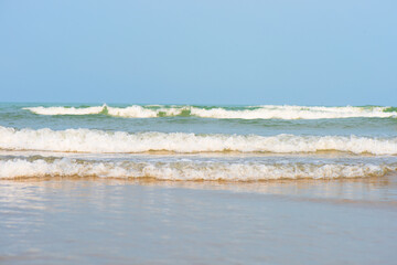 Bluewater waves on the surface ripples blurred. Defocus blurred transparent blue colored clear calm water surface texture with splash and bubbles. Water waves with shining pattern texture background.