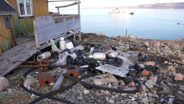 Cape Tobin, Greenland. Trash and Waste by Abandoned House and Coastline