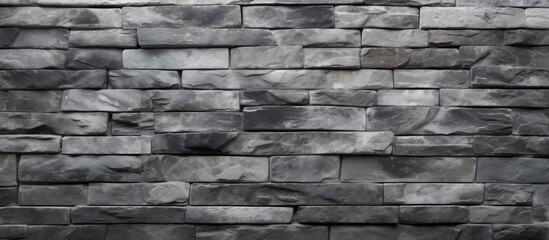 A detailed close up of a monochrome brick wall showcasing the grey rectangular bricks forming a...