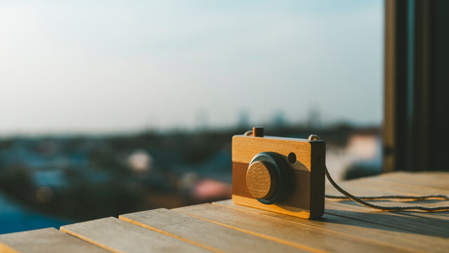 A camera toy was placed on the balcony to capture beautiful natural views, sunset scene. Selective focus.