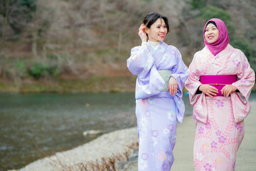 Travel, muslim travel, Arashiyama, woman girl tourist Two Asian friends but different religions in...