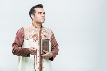 Ramadan, EIDMUBARAK, Portrait Asian Muslim man standing and reading the Quran and appreciates, The...