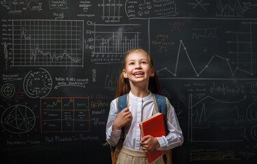 Kid in class on background of blackboard