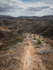 Bike trail through St. George Utah desert landscape on mountain ridge 