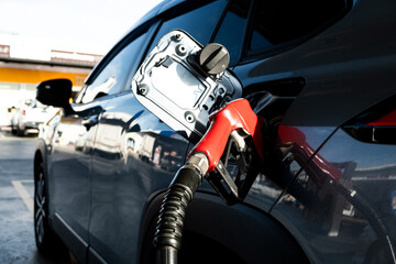 Car fueling at gas station. Refuel fill up with petrol gasoline. Petrol pump filling fuel nozzle in...