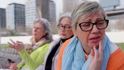 Mature despaired and bored woman listening to talkative friend.