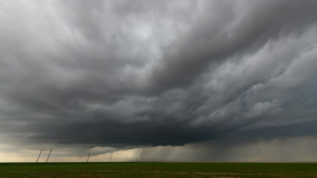 Clouds getting sucked into a storm as it strengthens and becomes tornado-warned.