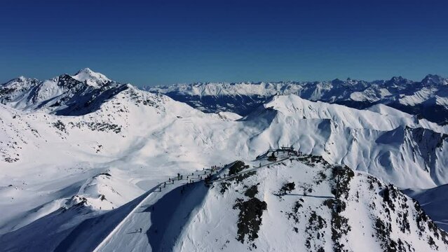 Summit in Alps with people getting off ski lift, Winter Sport Season
