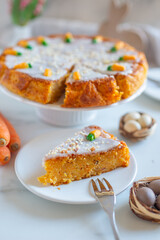 Carrot cake pie sprinkled with nuts decorated with cream-colored carrots