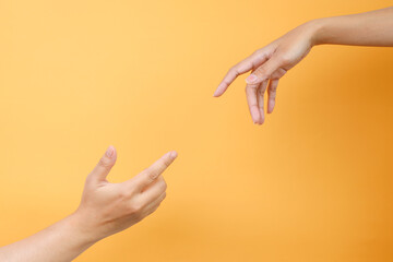 Two hands trying to touch each other. Concept of human relation, community and togetherness 