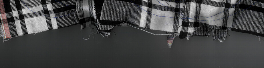 Detail of the black and white texture of the folded crumpled fabric with the threads visible very...