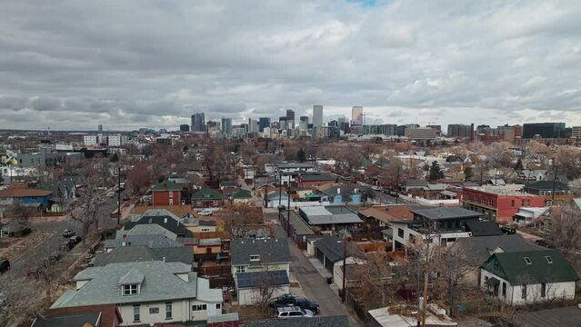 Wide angle aerial flyover above Denver Colorado city suburb in winter, cloudy day