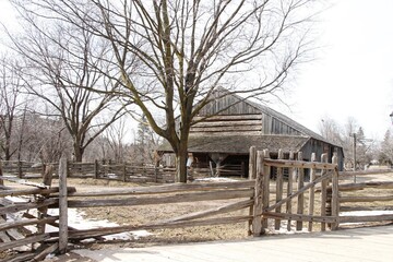 An old barn in the village, surrounded by a worn-out wooden fence