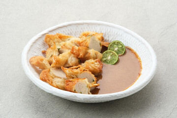 Batagor, made from fish or chicken dumpling, tofu, tapioca flour served with peanut sauce. Indonesian food

