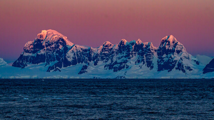 Sunset over a mountain range on Wiencke Island, Antarctica