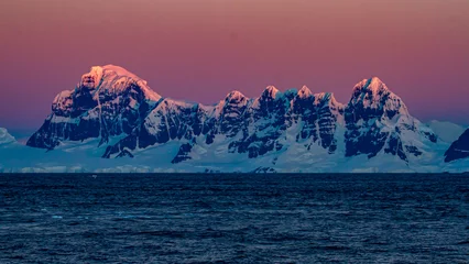 Foto op Canvas Sunset over a mountain range on Wiencke Island, Antarctica © Thomas