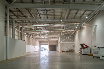 Spacious expansive warehouse interior with high ceilings, large open floor area. Concept of...