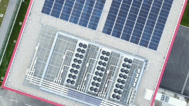 Top down drone shot above a air ventilation system and solar cells on a data center