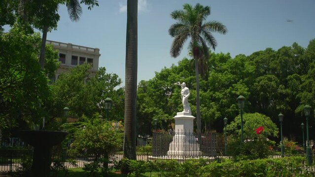 statue of a cuban hero on a clear day surrounded by vegetation in the plaza de armas in Cuba