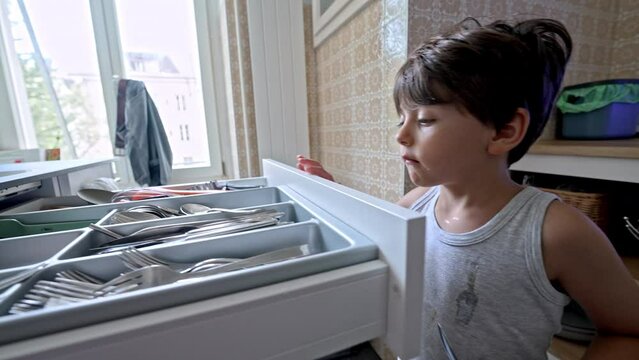 Toddler Corrects Mistake - Little Boy Returns Spare Spoon Back In Kitchen Cabinet